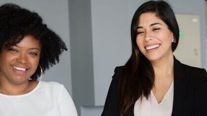 group of businesswomen smiling and laughing
