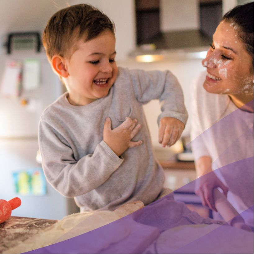 mom and son have fun baking bread in the kitchen