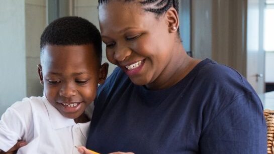 Mother helping son with homework
