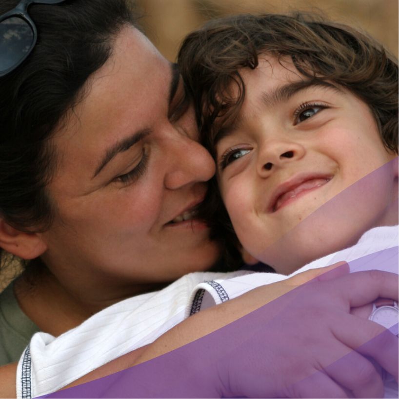 mom hugging her son closely