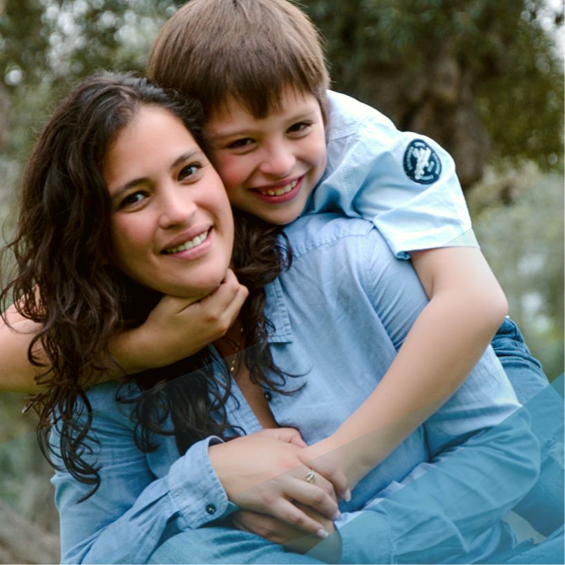 mom giving her son a piggyback ride outside