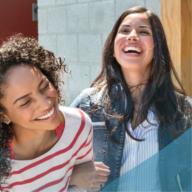 two women laughing with each other