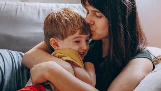 mom kisses her son on the head