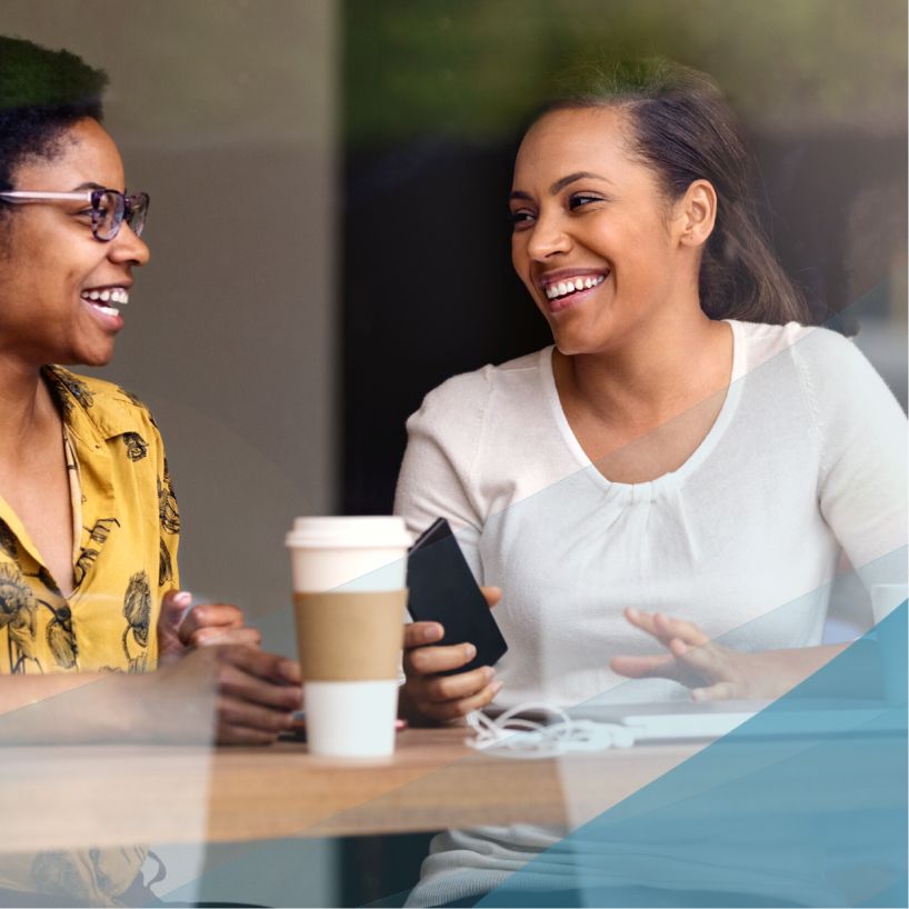 two women talk over coffee