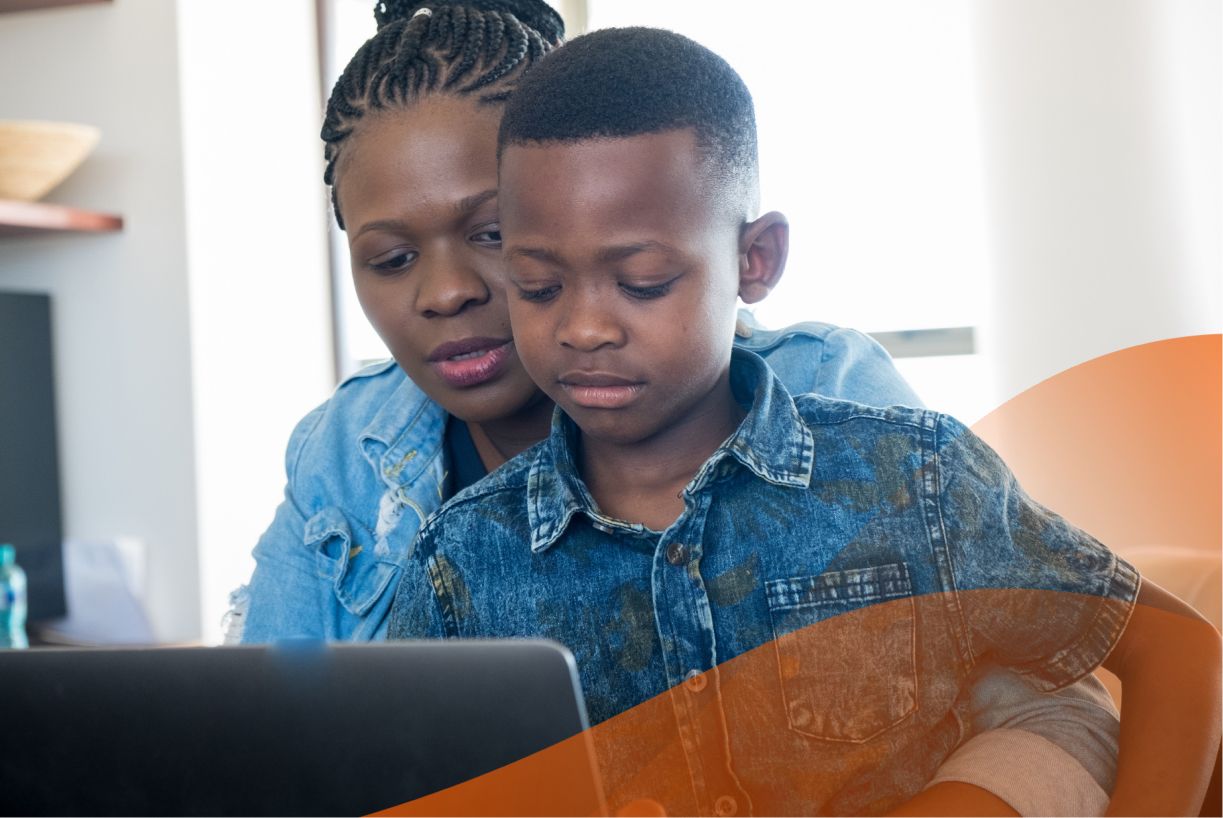 Woman taking an online course with son on her lap