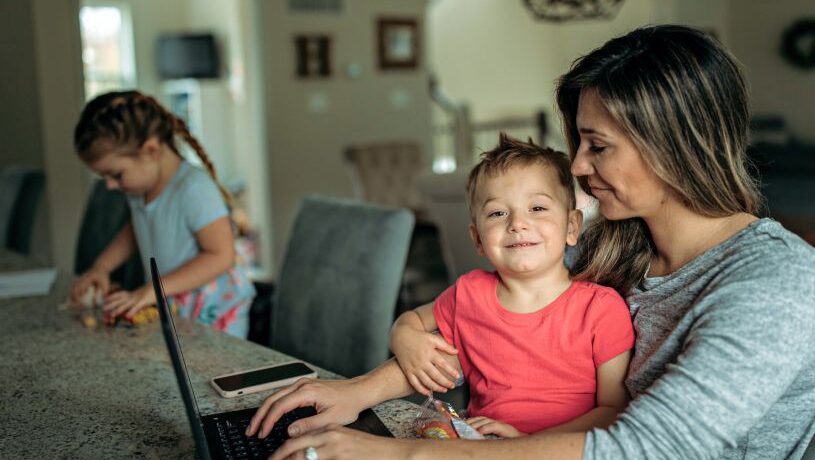 mother working with son on lap