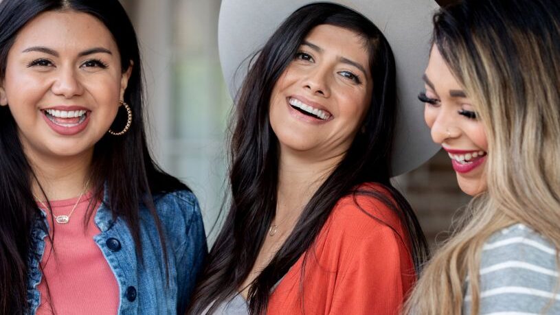 Three female friends laughing together