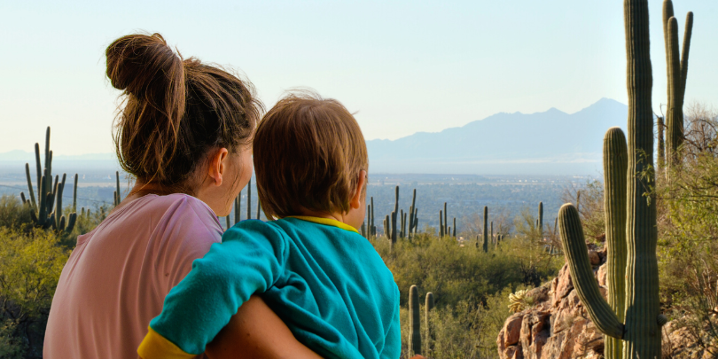 woman and child look over desert